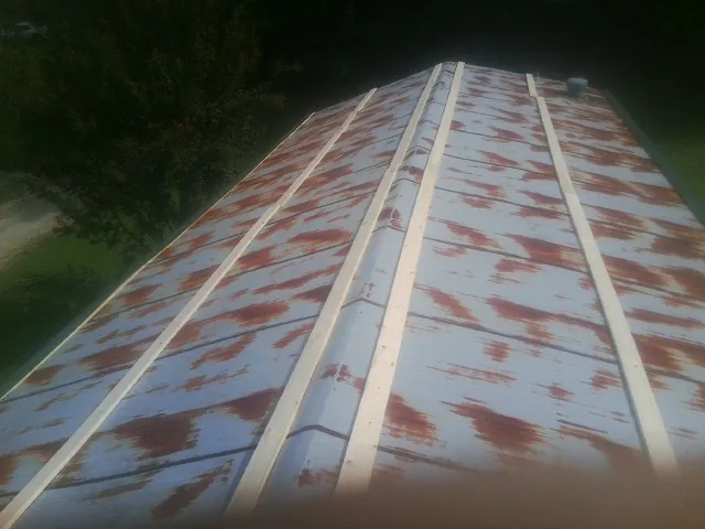 Rusted metal roof panels with new wood purlins before replacement — Storm Damage Roof Repair in Rosemead by Roofing Brothers